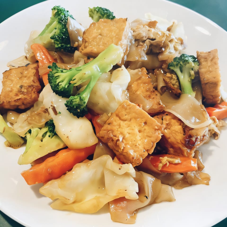 Thai Nakornping's Pad See Ew with tofu, broccoli, carrots, and wide rice noodles.